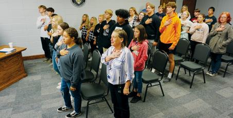 Almost two dozen members of the Noble Knights, a group that looks out for the welfare of fellow students, leads the Graham County Board of Education in the Pledge of Allegiance at the board’s meeting on Tuesday. Photo by Randy Foster/news@grahamstar.com