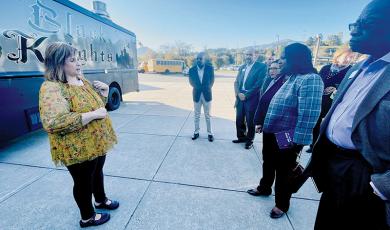 Graham County Schools Superintendent Angie Knight (left) shows representatives from Blue Cross NC Robbinsville High School’s Black Knights mobile food truck on Friday. Among Blue Cross NC officials were Dr. Tunde Sotunde, a pediatrician who is president and CEO of Blue Cross NC (center). Photo by Randy Foster/news@grahamstar.com