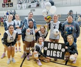 The Robbinsville Lady Knights surprised senior Kensley Phillips with gifts immediately after Oct. 6’s home match against Andrews, to help celebrate Phillips surpassing the 1,000-dig threshold. Surrounding Phillips are (back row, from left): Claire Barlow, Liz Carpenter, Aubrie Wachacha and team manager Eden Orr; (front row, from left): Fala Welch, Tai Owle and Olivia Lewis; kneeling in front, Delaney Brooms (left) and Suri Watty.