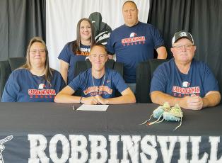 Robbinsville senior William Cable (seated, center) signed to run at Carson-Newman University on Monday. Sitting with Cable are parents Patsy (left) and Edward Cable. Standing in back are sister Jamie Carver and brother Patrick Cable. Photo by Kevin Hensley/sports@grahamstar.com
