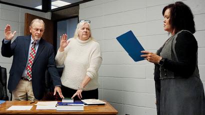 Clark “Chip” Carringer and Debra “Hank” Dinschel recite oaths of office administered by Graham County Clerk of Court Tammy Holloway at a special-called meeting of the Graham County Board of Education on Tuesday evening. Photo by Randy Foster/news@grahamstar.com