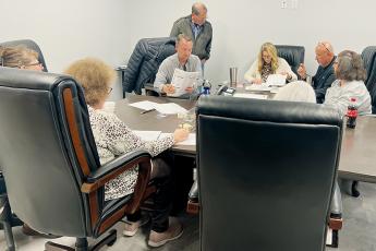 The Graham County Board of Elections sifts through ballots from the Nov. 8 election Friday, during a requested hand-to-eye recount in the race for the second seat on the Graham County Board of Education. Clockwise from top are board chair Juanita Colvard; board members Beefy Rogers and Teresa Eller; poll workers Tracy Jenkins and Lorna Sellers, who tallied the recount; local election director Teresa Garland; and board members Billy Ditmore and Lowell Crisp. Photo by Kevin Hensley/editor@grahamstar.com