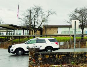 A Graham County deputy is shown stationed outside Robbinsville Elementary School on Dec. 7, after a bomb threat was phoned into the district’s tip line earlier that morning. Graham County Schools were shut down for the day as a safety precaution, with both sheriff’s deputies and state troopers protecting entrances to the schools until the situation was investigated. Photo by Kevin Hensley/editor@grahamstar.com