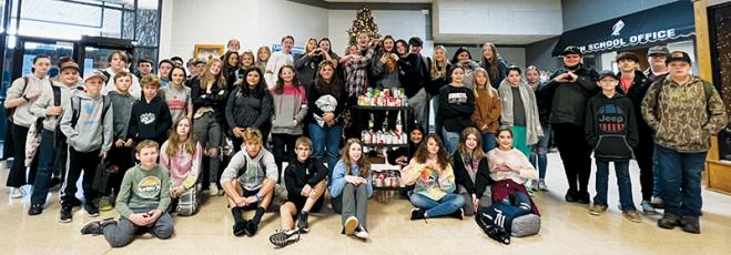 Robbinsville Middle School students assigned to the “Amistad” (Red) House gather around the 100-plus cans collected to help combat local hunger. Photo by Kevin Hensley/editor@grahamstar.com