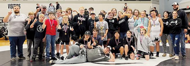 The Robbinsville Middle School wrestling team gathers to celebrate its 2022-23 Smoky Mountain Conference  tournament championship Dec. 15, moments after winning the title on their home mat.
