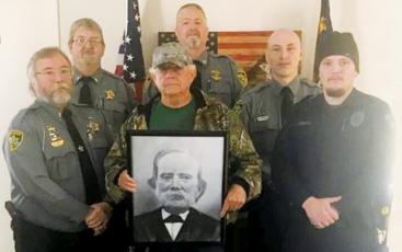 Standing with a portrait of J.S. Hyde, the first sheriff of Graham County in 1872, are law-enforcement ‘grandsons’ living in Graham County.