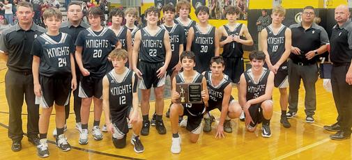 The Robbinsville Middle School Black Knights gathered on the court with their  runner-up plaque after the conference-tournament finale Jan. 19 at Murphy. 