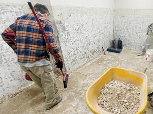 An unidentified worker looks over the floor of a bathroom that has been closed for remodeling at the Graham County Community Building. A pipe burst around the remodel overnight Friday, causing the county offices to close. As of Tuesday, the offices have not reopened. Photos by Randy Foster/news@grahamstar.com