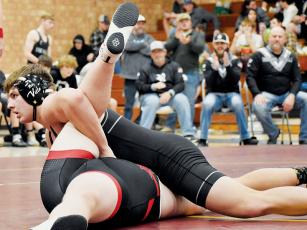 Koleson Dooley defiantly pins Avery County’s Connor Brewer in the heavyweight bout of Feb. 1’s Western Regional Finals match at Swain. Dooley’s pin gave Robbinsville an 18-6 lead, but the Vikings would rally and advance to the state-dual championship. Photo by Kevin Hensley/sports@grahamstar.com