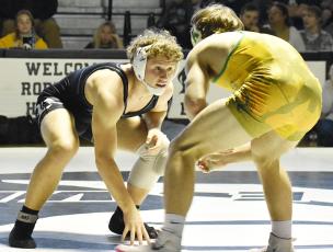 Black Knights senior Turner Jackson stares down Alleghany's Isaac Stokes at the outset of Jan. 28's, second-round state dual-team tournament match in Robbinsville. Photo by Kevin Hensley/sports@grahamstar.com
