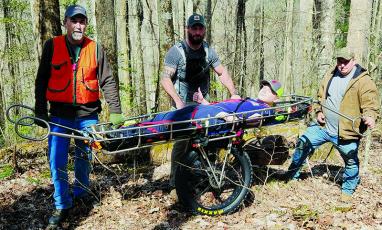 From left are Graham County Rescue Squad members Larry Crisp, Brent Eller and Zeb Hutchisen with “victim” David Grant on the stretcher during a Saturday training exercise on Stratton Bald Trail. Photo courtesy of Tory Lynnes/Graham County Rescue Squad