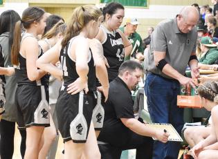Lady Knights head coach Lucas Ford draws up a play during a timeout at Feb. 25's, third-round postseason game against Eastern Randolph. Photo by Montana Buchanan/The Graham Star