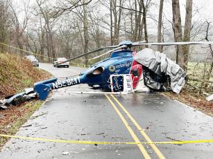 Wreckage of Life Force 6 blocks Middle Burningtown Road in Macon County on Friday on the morning following a crash. All four aboard survived. Photo by Mia Overton/The Franklin Press