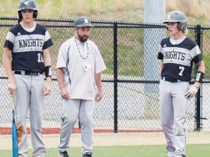 Lathan Buchanan, Robbinsville head coach Brent Icenhower and Alex Knight (from left) have a on-field discussion during a pitching change against Brevard on April 11. Buchanan and Knight are two of the seniors back for the varsity-baseball program this season. Photos courtesy of Crystal White/Robbinsville High School