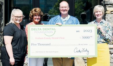 The Delta Dental Foundation of North Carolina paid a visit to the Graham County Dental Clinic on June 13, to present a $5,000 check on behalf of the 2023 Smiles for Kids award program. From left are dental assistant Macy Rogers, Graham County Health Director Donna Stephens, Dr. Rory Frederick of the county dental office and Elaine Loyack, vice president of community engagement and community relations for Delta Dental Foundation. Photo by Kevin Hensley/editor@grahamstar.com