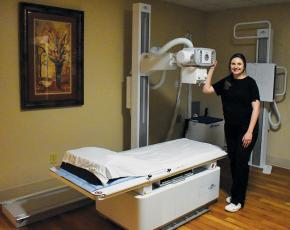 Appalachian Mountain Community Health Center’s Hannah Anderson has not stopped beaming with pride about the clinic’s new x-ray machine, which arrived earlier this month. Photo by Kevin Hensley/editor@grahamstar.com