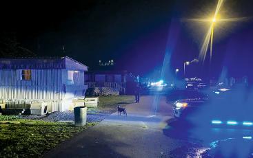 Blue lights pierced the nighttime sky late Friday, as members of the Graham County Sheriff’s Office executed a pair of search warrants in Robbinsville. All told, seven individuals were arrested from two different homes off Ford Street. Photos by Kevin Hensley/editor@grahamstar.com