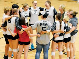 Members of the Lady Knights volleyball team gather to sing the Robbinsville High School alma mater – a post-match tradition, when a victory is in the books – after Tuesday’s sweep over the Blue Ridge Bobcats. Photo by Kevin Hensley/sports@grahamstar.com