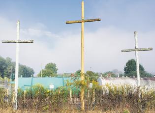 These three wooden crosses tower over Tallulah Road, near the county’s department of transportation office. Photo by Eric Reece/The Graham Star