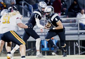 Cuttler Adams (4) takes the handoff from Robbinsville quarterback Donovan  Carpenter during the 2023 playoff opener Friday against Thomas Jefferson Classical Academy. Adams broke both the all-time rushing record for the Black Knights and the Smoky Mountain Conference early in the game. Photo courtesy of Miranda Buchanan/Robbinsville High School