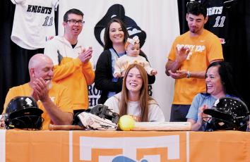 Smiles broke out all around Nov. 8, moments after Lady Knights senior Zoie Shuler signed her National Letter of Intent to play softball for the University of Tennessee. Shuler was surrounded by her father Michael (seated, left) and mother Kylie. Standing in back are her siblings: Trace, Taylor (holding Zoie’s niece Ayla) and Jeb. Photos by Kevin Hensley/sports@grahamstar.com