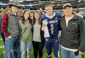 Cuttler Adams scored a touchdown and rushed for over 100 yards in the Jan. 8 Blue/Grey All-American Bowl, which led to the much-heralded running back receiving the game’s MVP award.  Adams is pictured on the field at Cowboys Stadium with his family (from left): Tillman, Chloe, Brandi and Coy Adams.