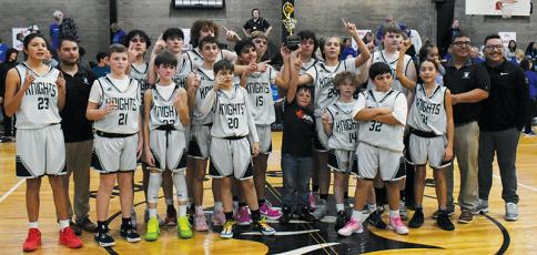 Capping off a 17-0 season, the Robbinsville Middle School Black Knights relish the moment after winning the Smoky Mountain Conference tournament Jan. 24. Photos by Fala Welch/The Graham Star