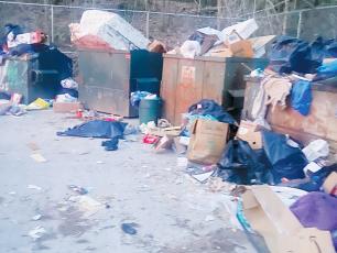 Since reverting back to the former 24-hour convenience of several Graham County sanitation centers, early-morning sights like this one March 11 at the Bear Creek location have become more commonplace.