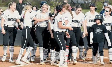 Nothing could erase the smile of Anna Williams (4), who was greeted by her exuberant teammates following her first varsity home run Monday against Enka. Photo by Jacquline Gayosso/The Graham Star