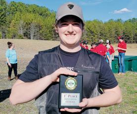 Robbinsville’s Ryan Lynn proudly displays his first place award March 16, after  winning the individual race at the district tournament in Polk County. Photo courtesy of Cheri Lynn/Robbinsville Shooting Team